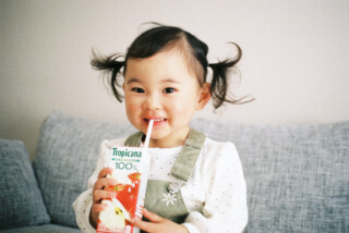 子供が飲み物持って笑っている画像